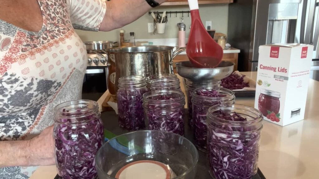 Pouring tasty brine mixture into jars