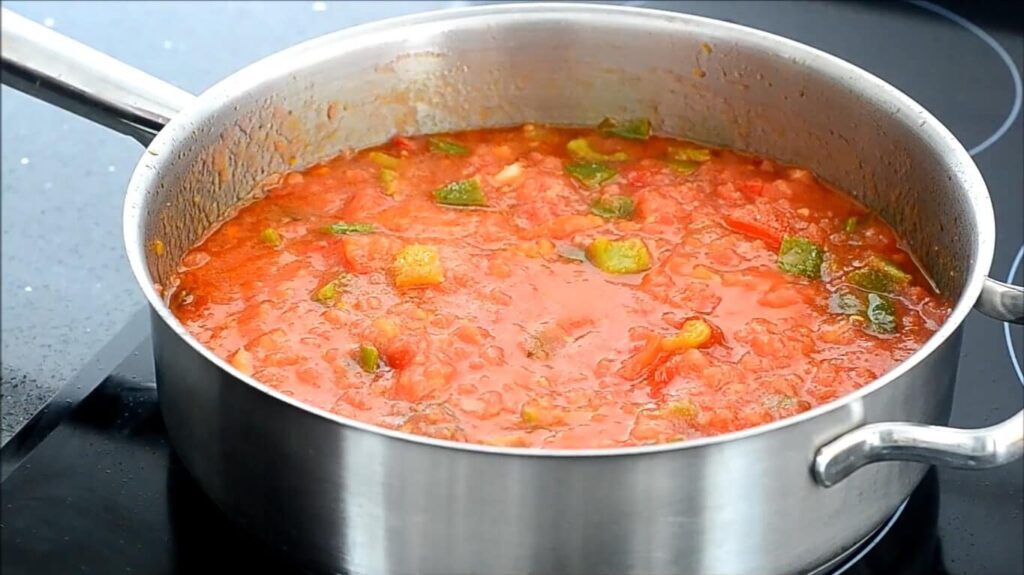 Slowly simmering mixture of tomato purée, pepper and dont forget to add some sugar to balance the acidity taste of tomato