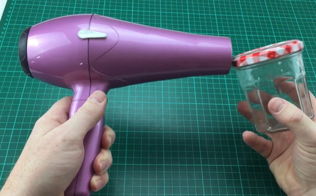 how to open sealed mason jar Aim and direct the hair drier at the lid 1 or 2 minutes, ensuring that the stream of warm air is centered on the ring