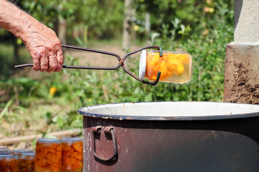 how to water bath can without a canner use jar lifter to protect your hand from hot canning jar