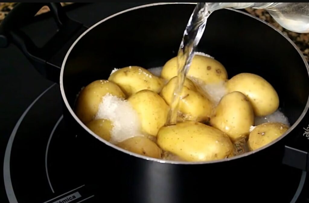papas arrugadas con mojo Put all of the washed and peeled potatoes in the pot, then season the salt and add water